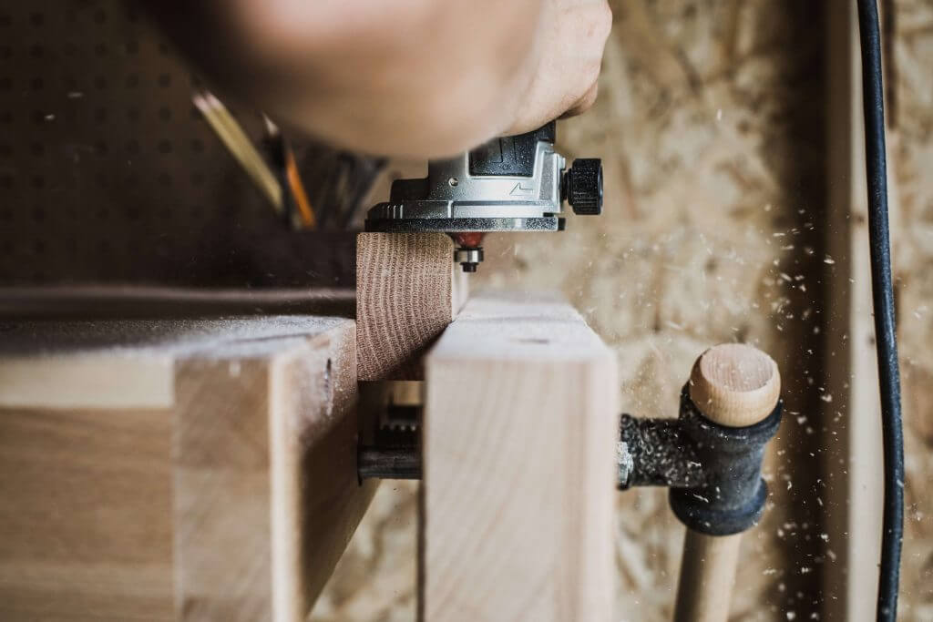 carpenter working with router joinery