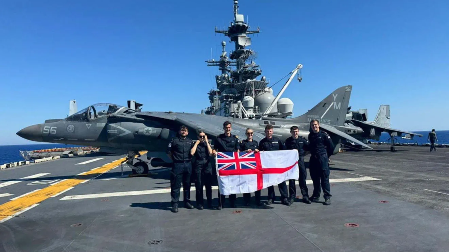 Royal Navy soldiers in front of aeroplane