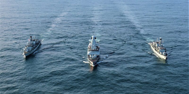 three naval ships at sea after repairs